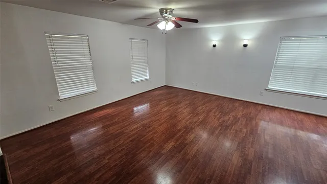 wooden floor in an empty room with a window