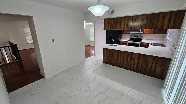 a kitchen with stainless steel appliances a refrigerator and a sink