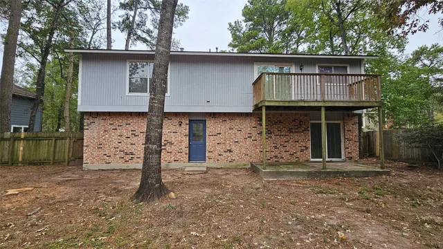 a view of a house with a door and wooden fence