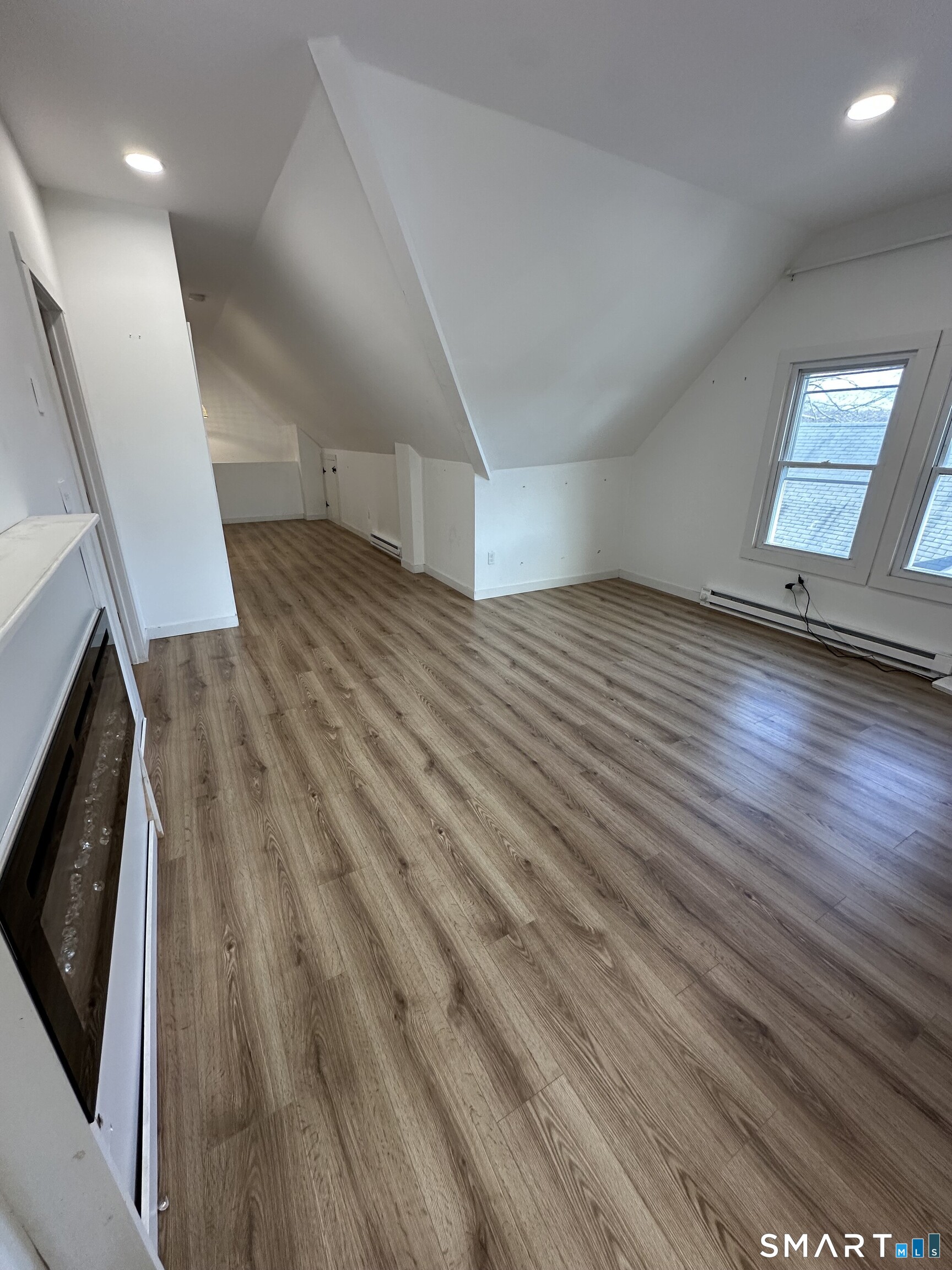 27 East 9th Street Derby, CT 06418 - Photo 12 of 22 an empty room with wooden floor and windows