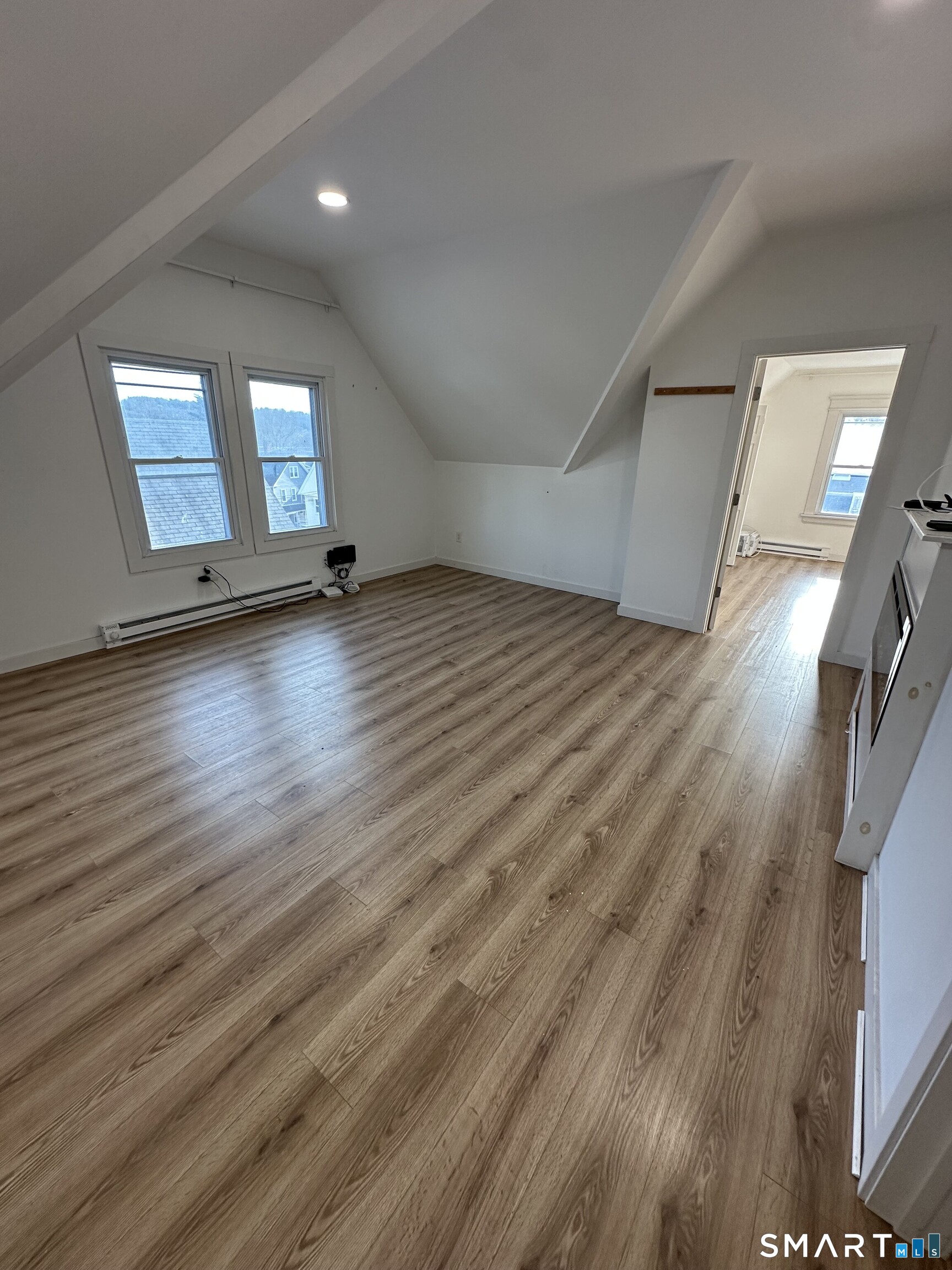 27 East 9th Street Derby, CT 06418 - Photo 13 of 22 a view of empty room with wooden floor and fan