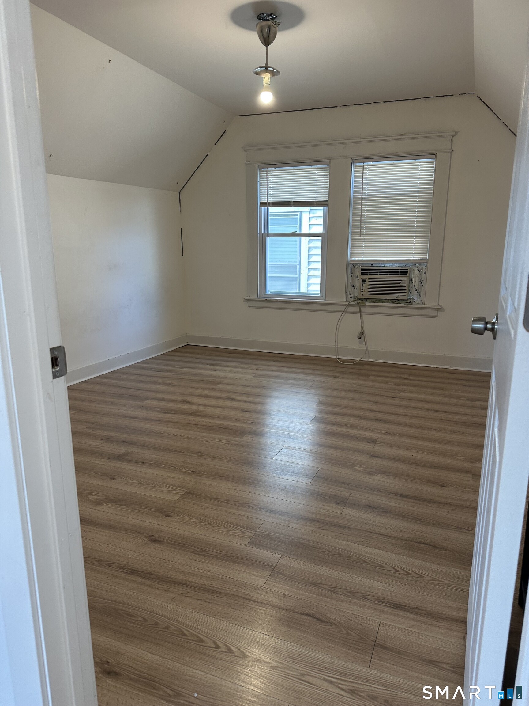 27 East 9th Street Derby, CT 06418 - Photo 18 of 22 an empty room with wooden floor and windows