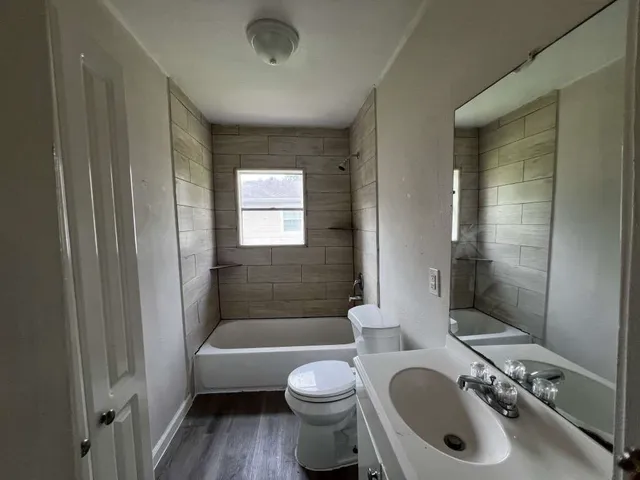 a bathroom with a toilet a sink and bathtub