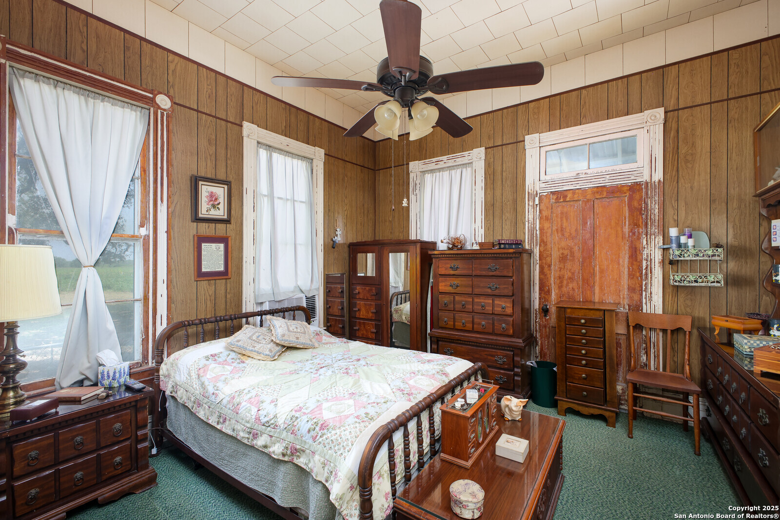 4901 Lower Seguin Road Cibolo, TX 78108 - Photo 24 of 41 a bedroom with a bed a dresser and a chandelier