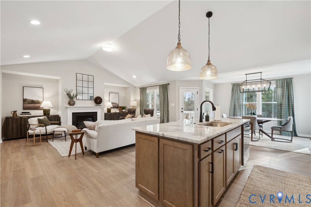 535 Wendenburg Terrace, Unit MODEL Aylett, VA 23009 - Photo 10 of 31 Kitchen with brown cabinetry, light stone counters