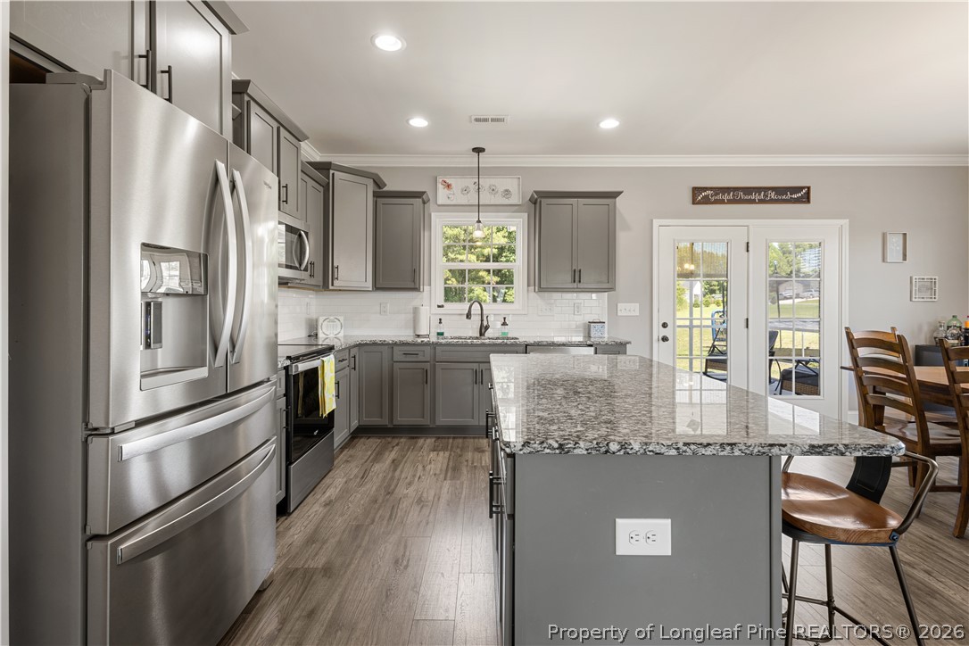 137 Minter School Road Sanford, NC 27332 - Photo 4 of 50 a kitchen with stainless steel appliances granite countertop a refrigerator and a sink