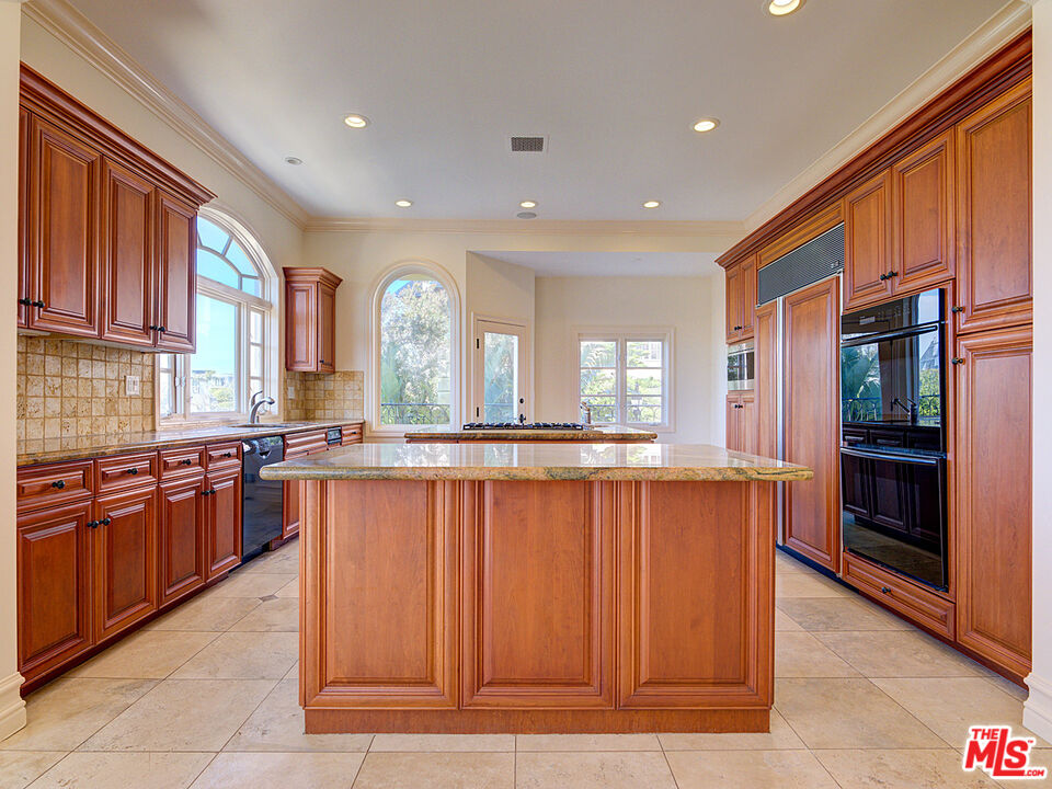 5003 Roma Court Venice, CA 90292 - Photo 11 of 34 a large kitchen with granite countertop a large counter top stainless steel appliances and cabinets