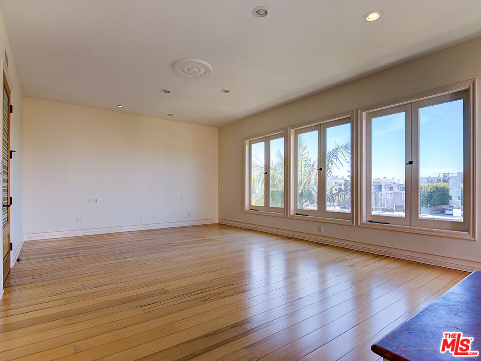 5003 Roma Court Venice, CA 90292 - Photo 21 of 34 a view of an empty room with wooden floor and a window