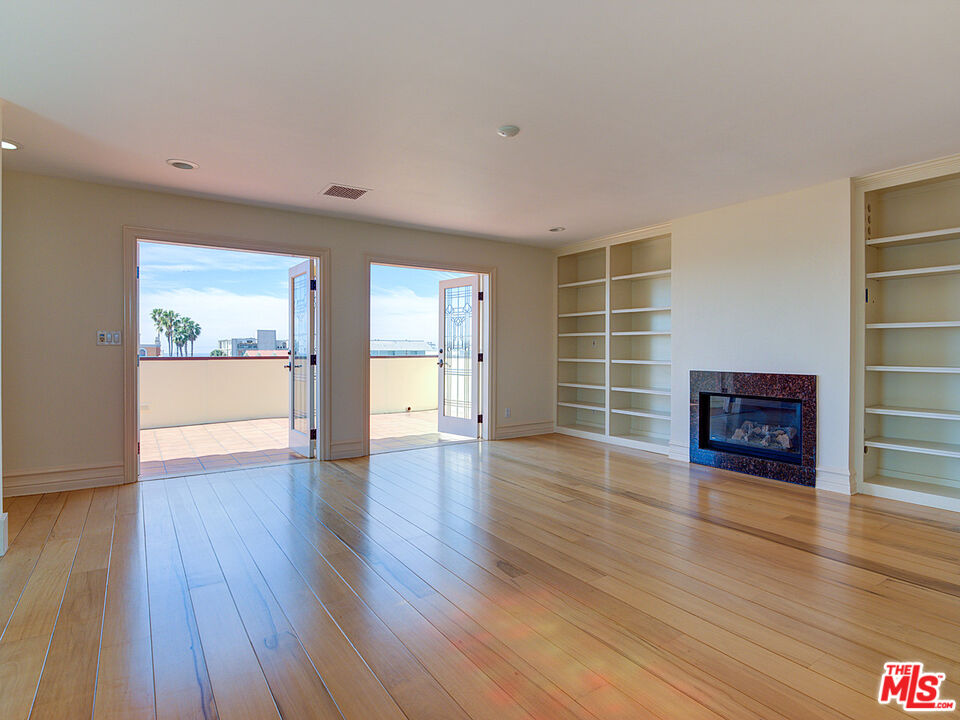 5003 Roma Court Venice, CA 90292 - Photo 27 of 34 a view of an empty room with a window and wooden floor