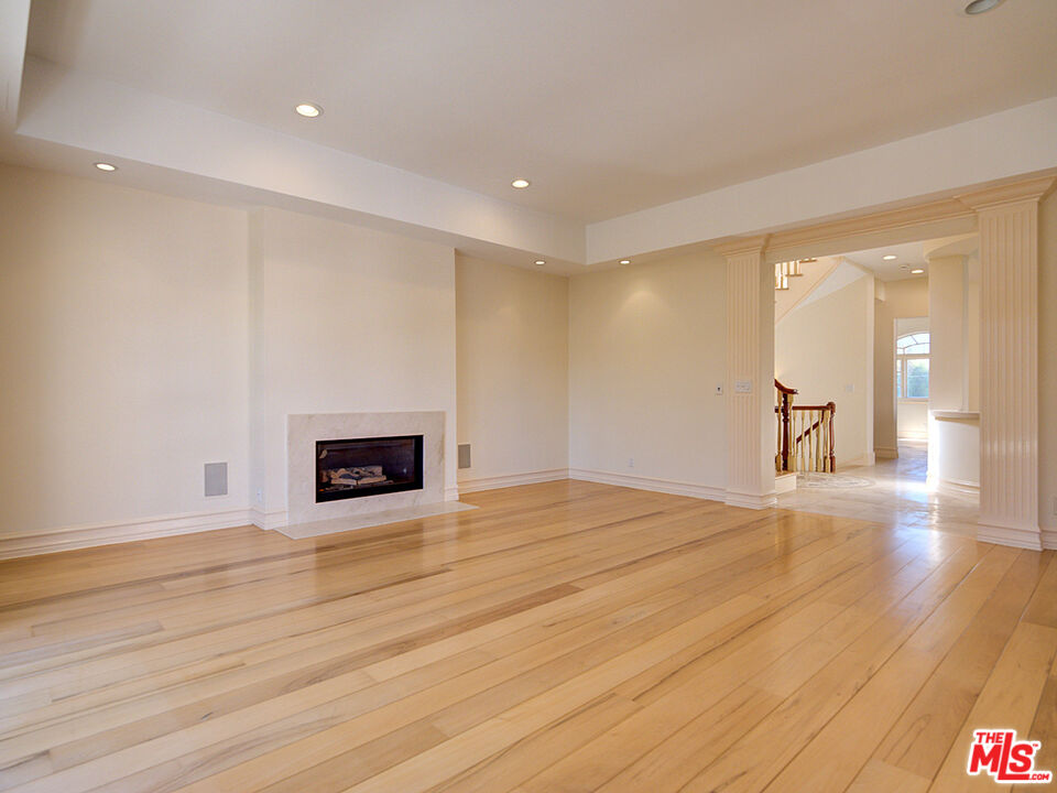 5003 Roma Court Venice, CA 90292 - Photo 4 of 34 a view of an empty room with wooden floor and a fireplace