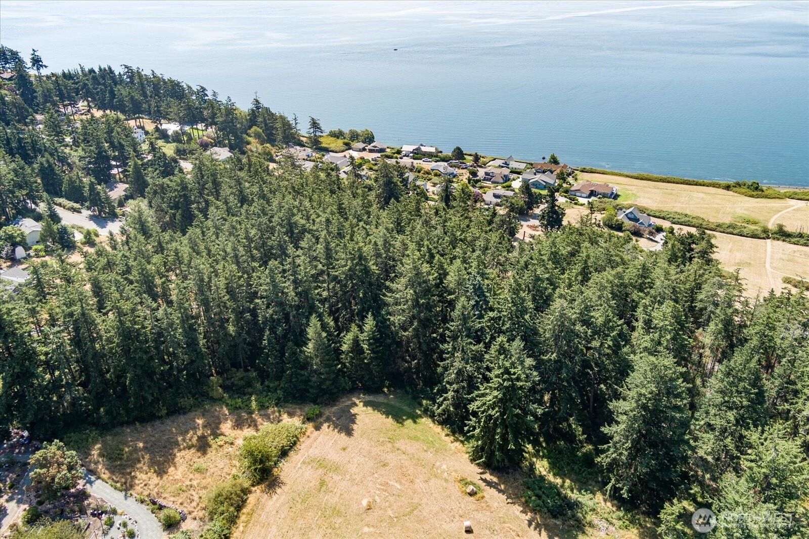 0 Old Polnell Road Oak Harbor, WA 98277 - Photo 5 of 10 a view of a lake with a building in the background