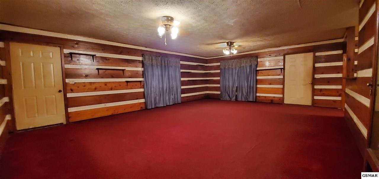 2485 Happy Hollow Road Sevierville, TN 37862 - Photo 25 of 35 a view of an empty room with a fireplace and cabinets