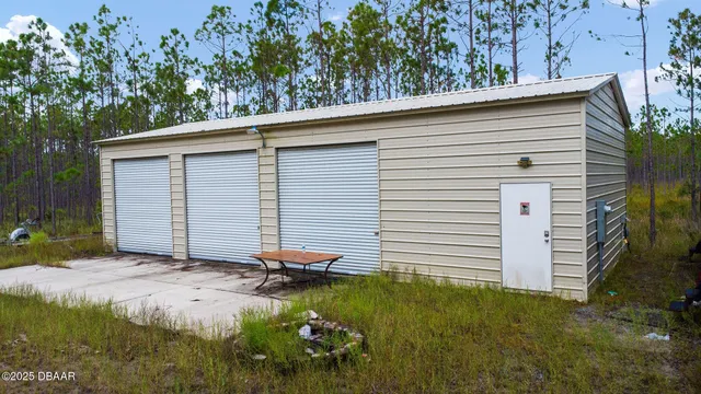 a bathroom with a yard and tree in the background