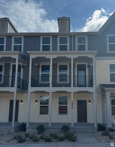 1472 North 1875 West, Unit 151 Layton, UT 84041 - Photo 1 of 20 Multi-level townhome-style residence featuring a contemporary facade with light-colored siding and vertical dark blue siding accents