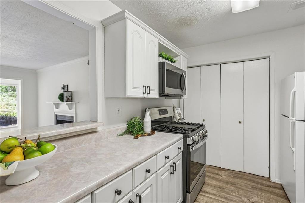 1601 Countryside Place Smyrna, GA 30080 - Photo 13 of 27 a kitchen with stainless steel appliances granite countertop a sink a stove a refrigerator a stove a microwave and cabinets