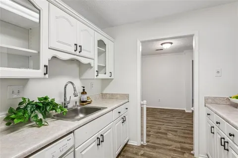 a kitchen with white cabinets and a sink