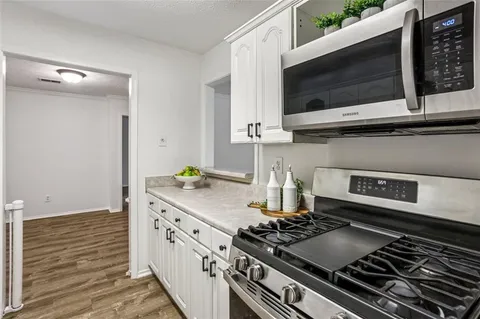 a kitchen with a stove and a microwave
