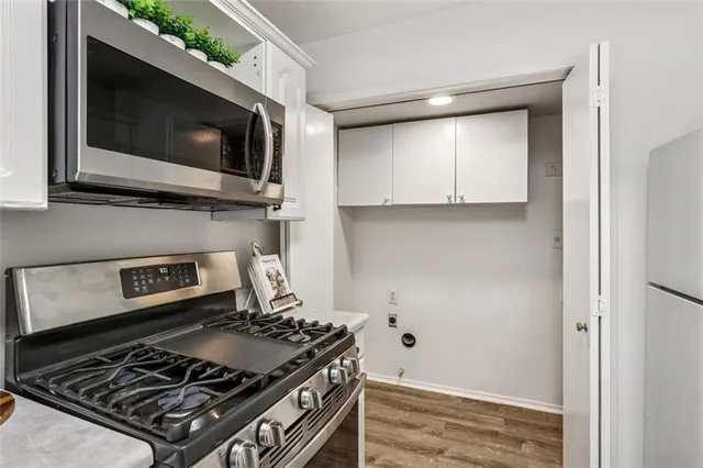 a kitchen with a stove and a microwave