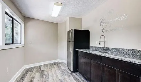 a kitchen with a sink and refrigerator