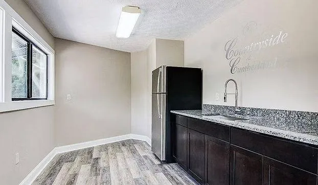 a kitchen with a sink and refrigerator