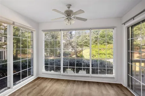 a view of a room with wooden floor and a window