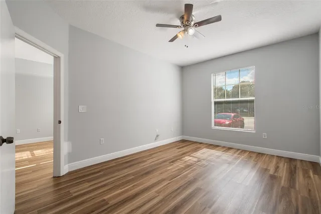 wooden floor in an empty room with a window