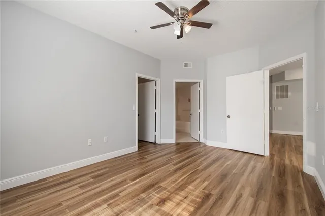 a view of a room with wooden floor and window