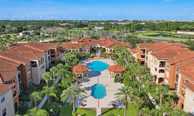 an aerial view of residential houses with outdoor space and street view