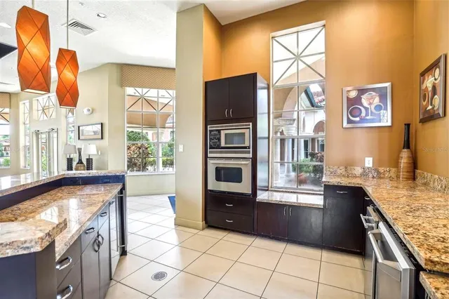 a kitchen with stainless steel appliances granite countertop a refrigerator and a sink