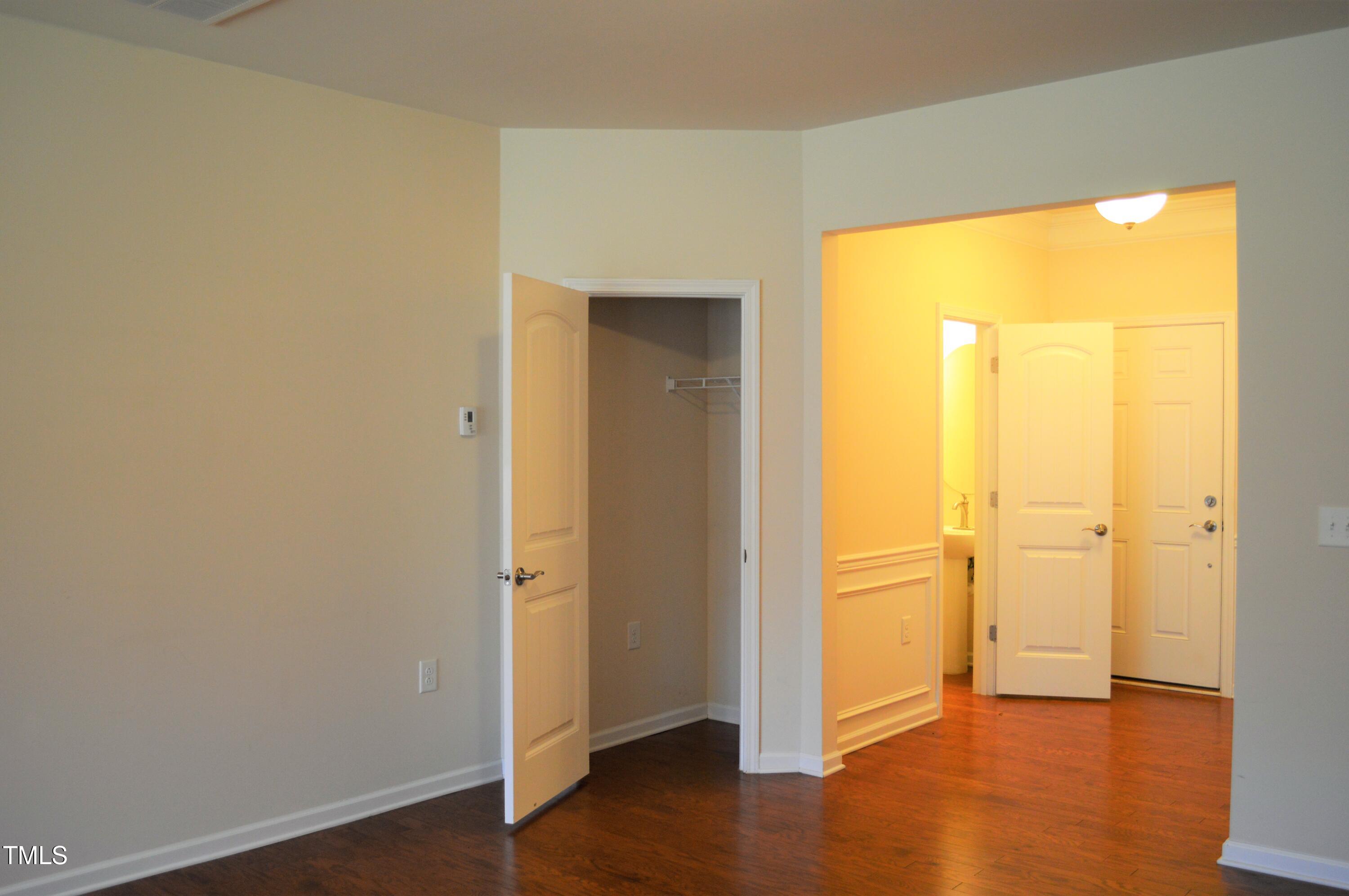 127 Brier Crossings Loop Durham, NC 27703 - Photo 3 of 14 an empty room with wooden floor and a window