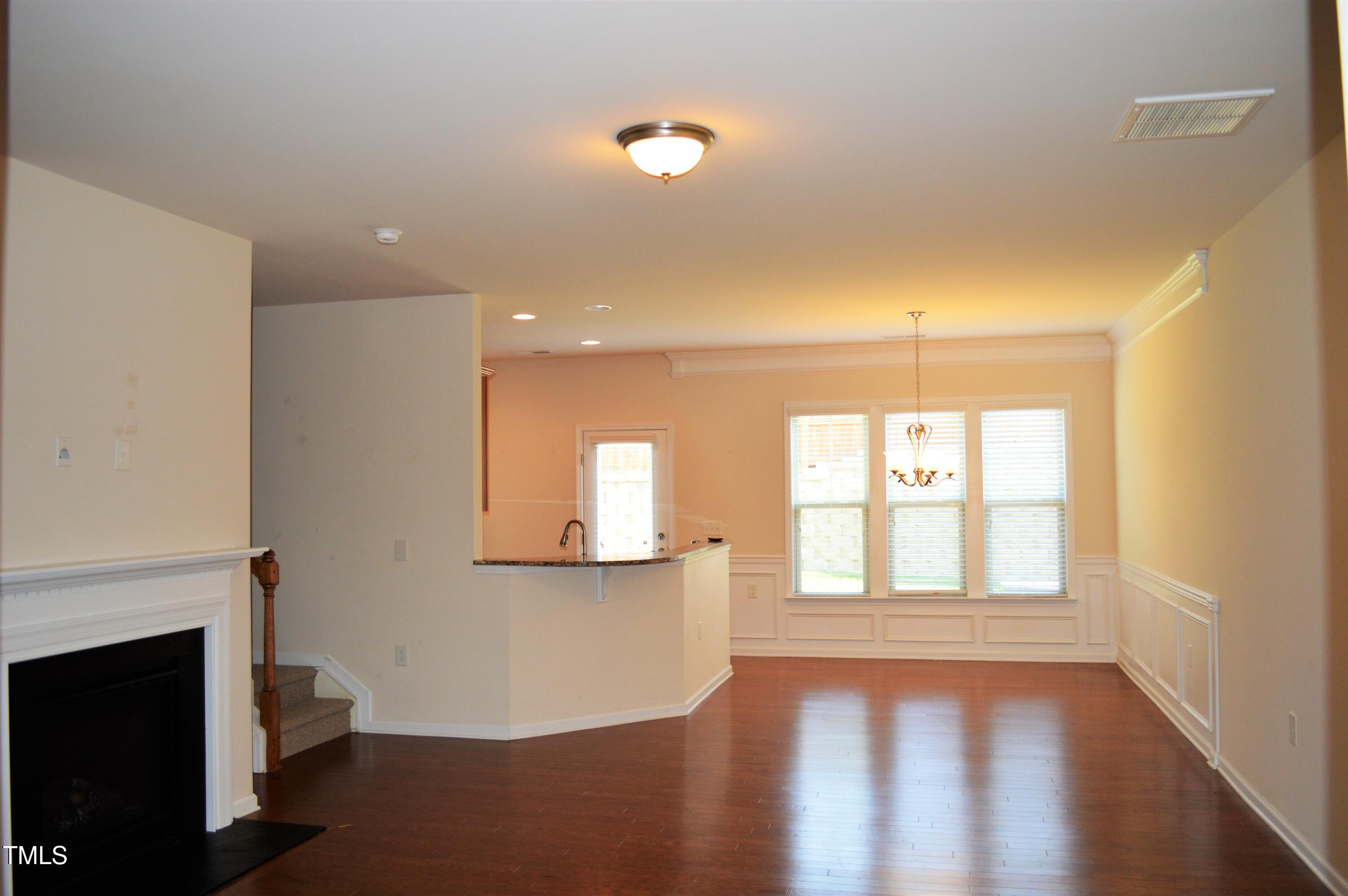 127 Brier Crossings Loop Durham, NC 27703 - Photo 4 of 14 a view of an empty room with wooden floor and a window