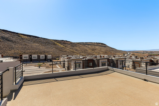 839 Walker Way St. George, UT 84770 - Photo 2 of 32 Expansive rooftop patio with textured flooring and black metal railings