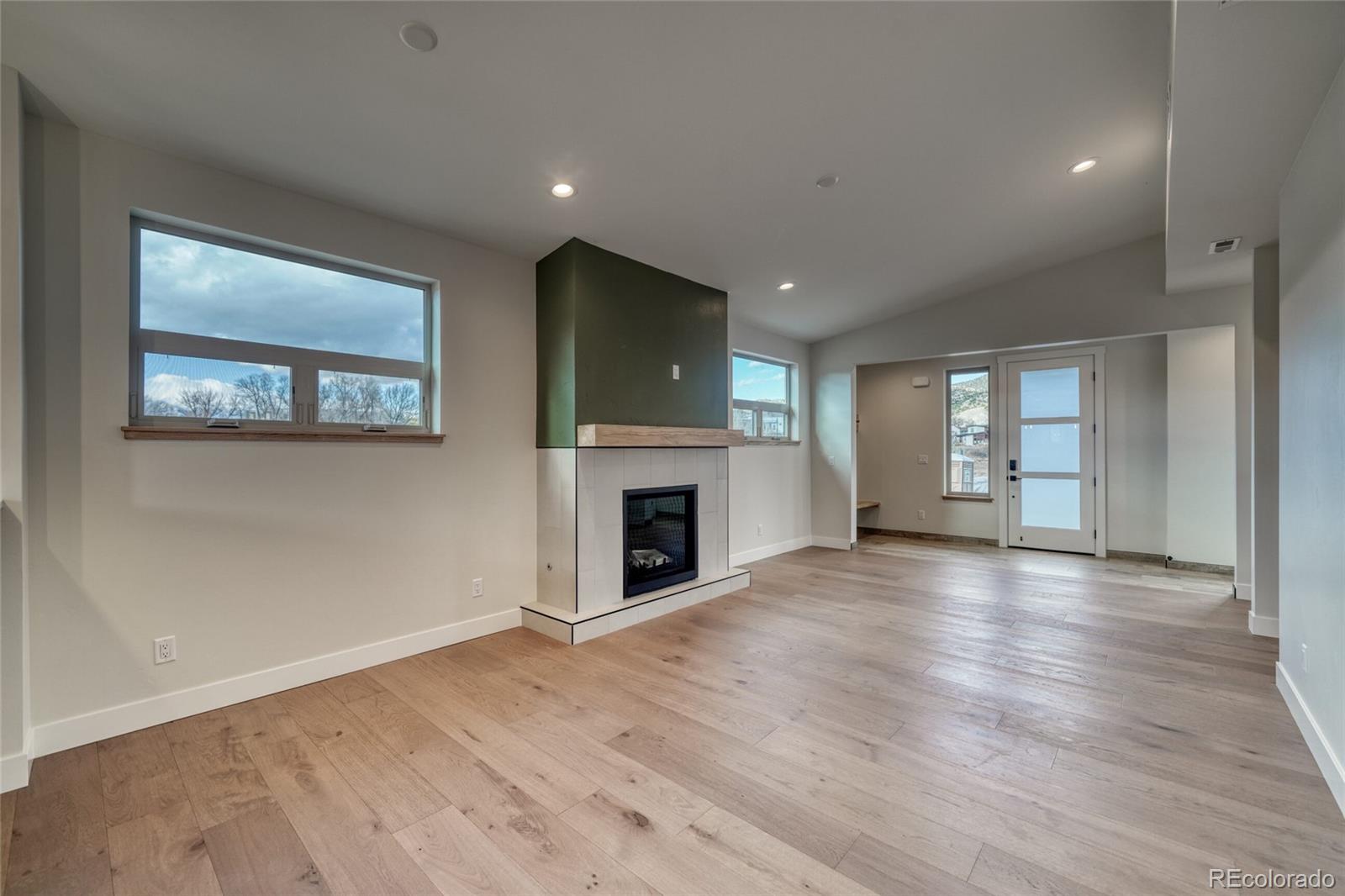 211 Southside Loop Salida, CO 81201 - Photo 12 of 39 a view of a livingroom with wooden floor and a fireplace