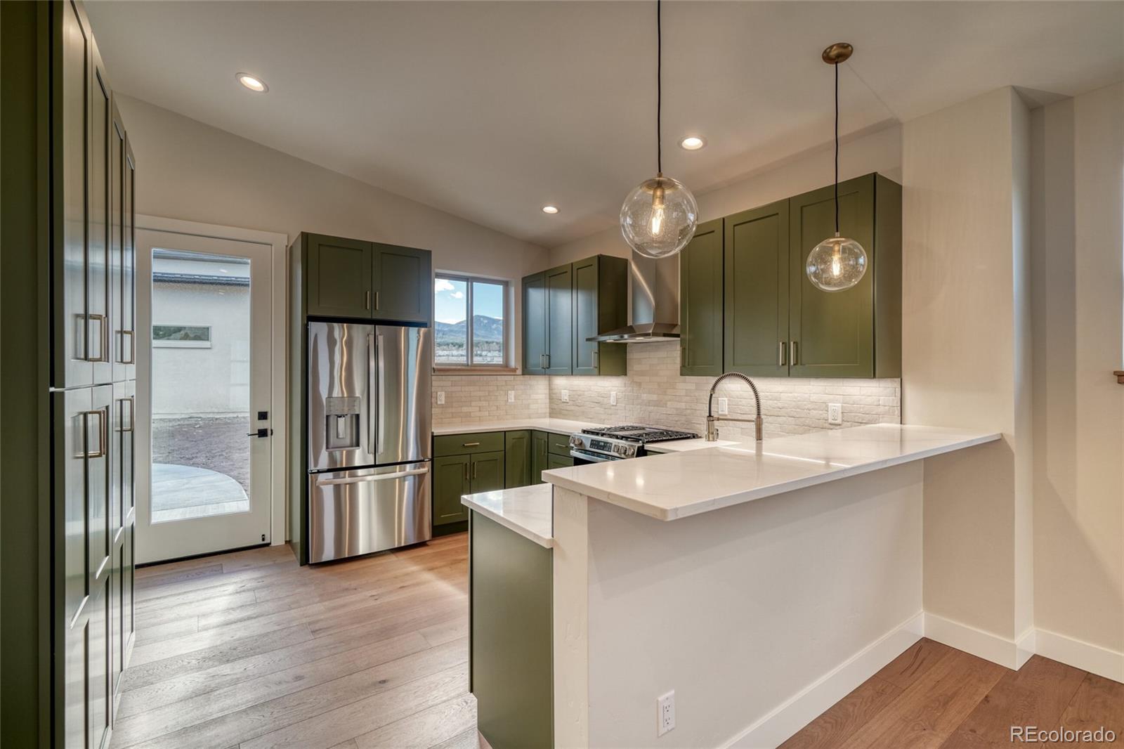211 Southside Loop Salida, CO 81201 - Photo 14 of 39 a kitchen with stainless steel appliances granite countertop a refrigerator a sink and a stove