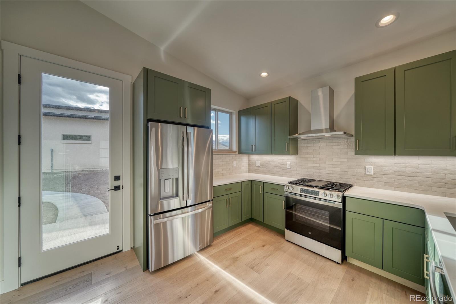 211 Southside Loop Salida, CO 81201 - Photo 15 of 39 a kitchen with stainless steel appliances granite countertop a refrigerator and a sink