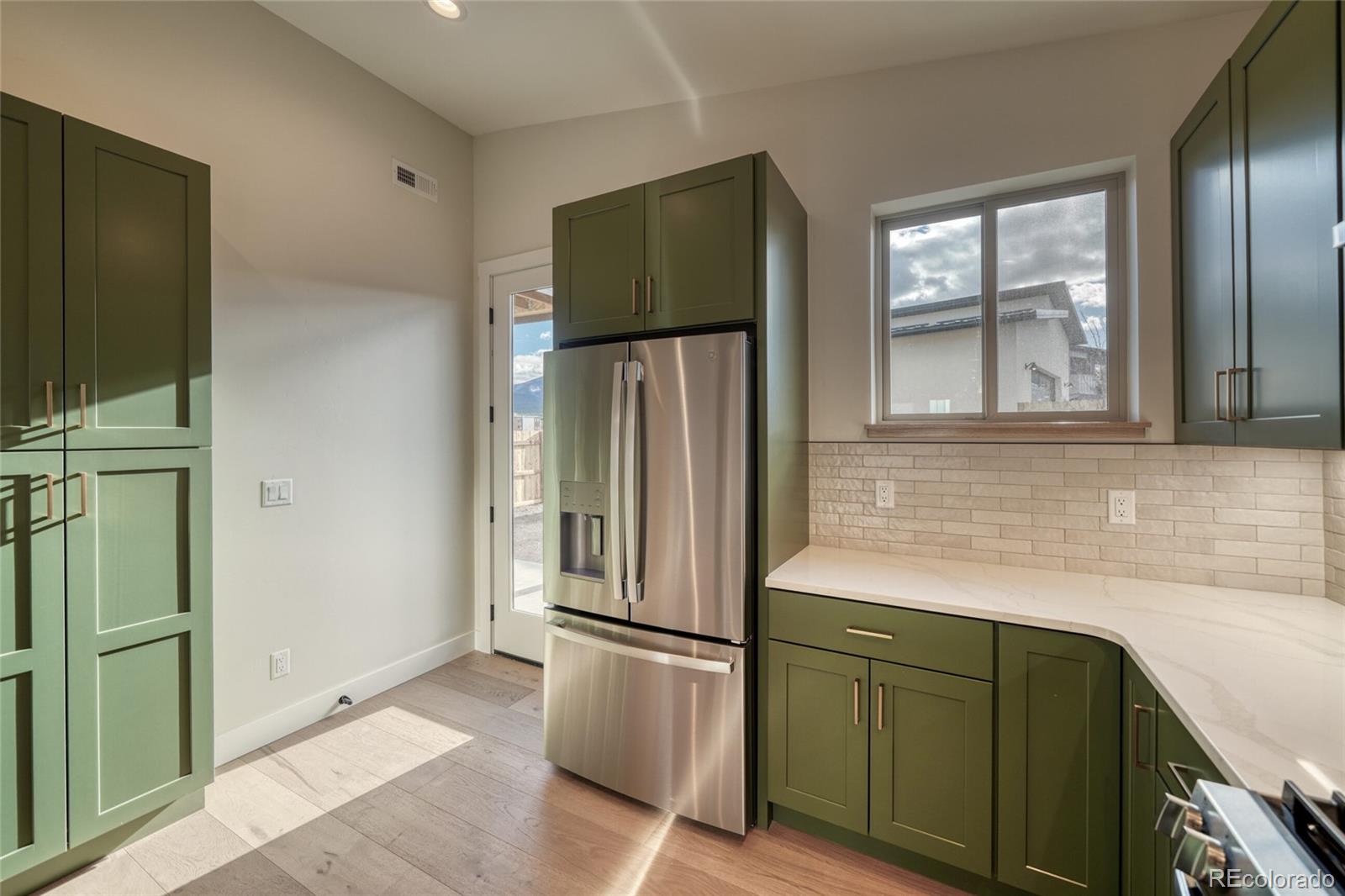211 Southside Loop Salida, CO 81201 - Photo 18 of 39 a kitchen with stainless steel appliances granite countertop a refrigerator and a sink