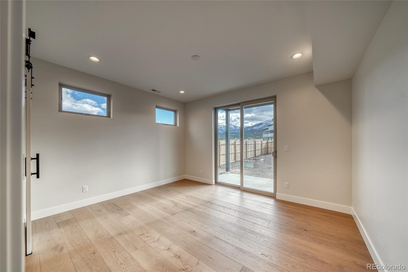 211 Southside Loop Salida, CO 81201 - Photo 20 of 39 an empty room with wooden floor and windows