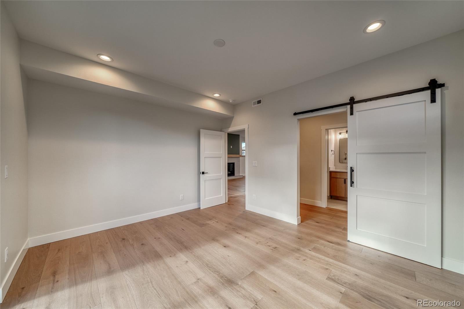 211 Southside Loop Salida, CO 81201 - Photo 21 of 39 a view of an empty room with wooden floor and a window