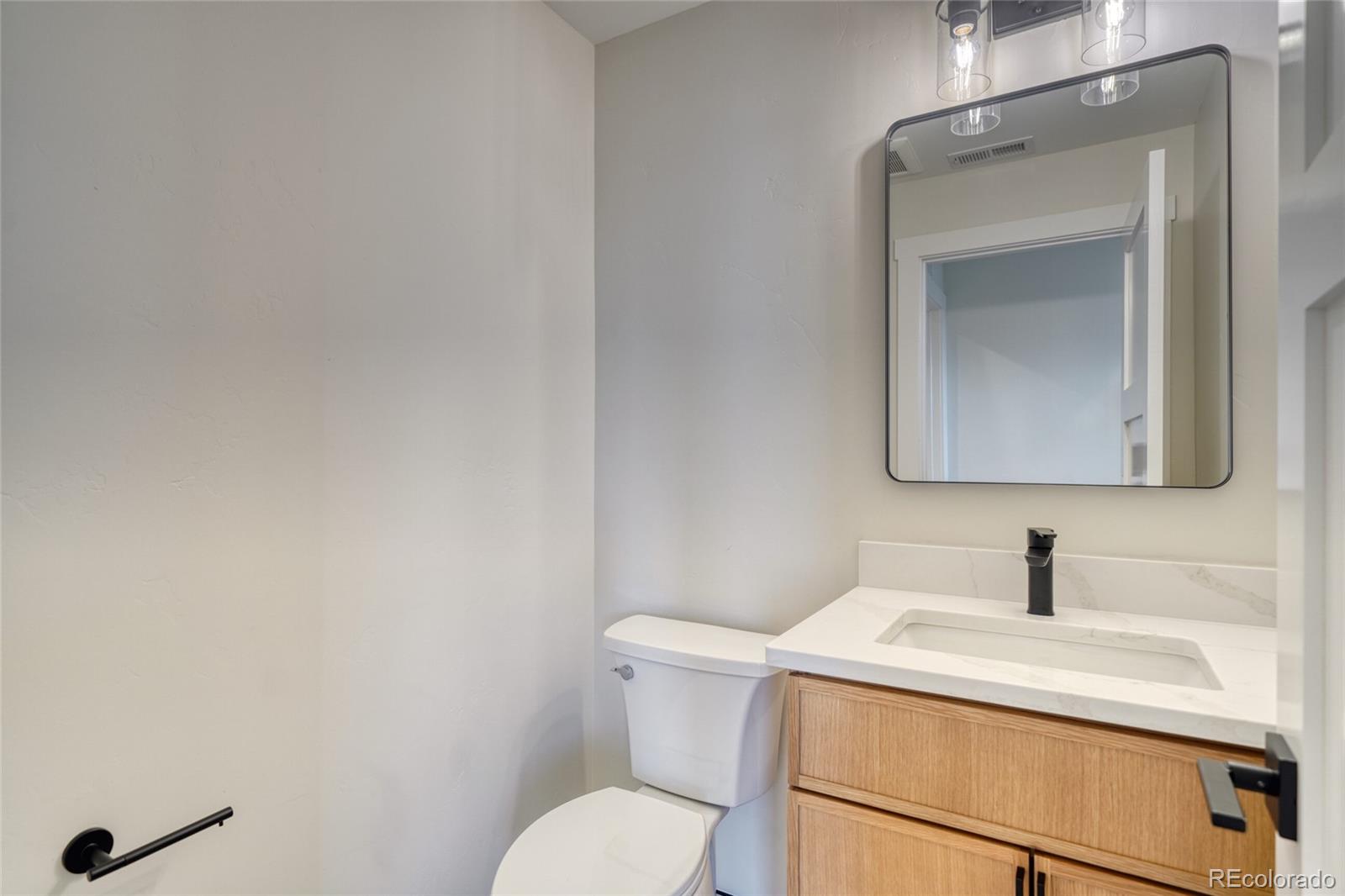 211 Southside Loop Salida, CO 81201 - Photo 25 of 39 a bathroom with a toilet sink and mirror