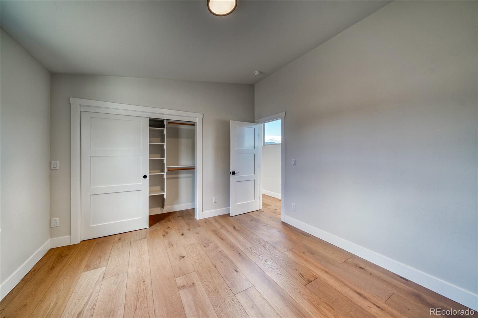 211 Southside Loop Salida, CO 81201 - Photo 30 of 39 a view of an empty room with a window and wooden floor