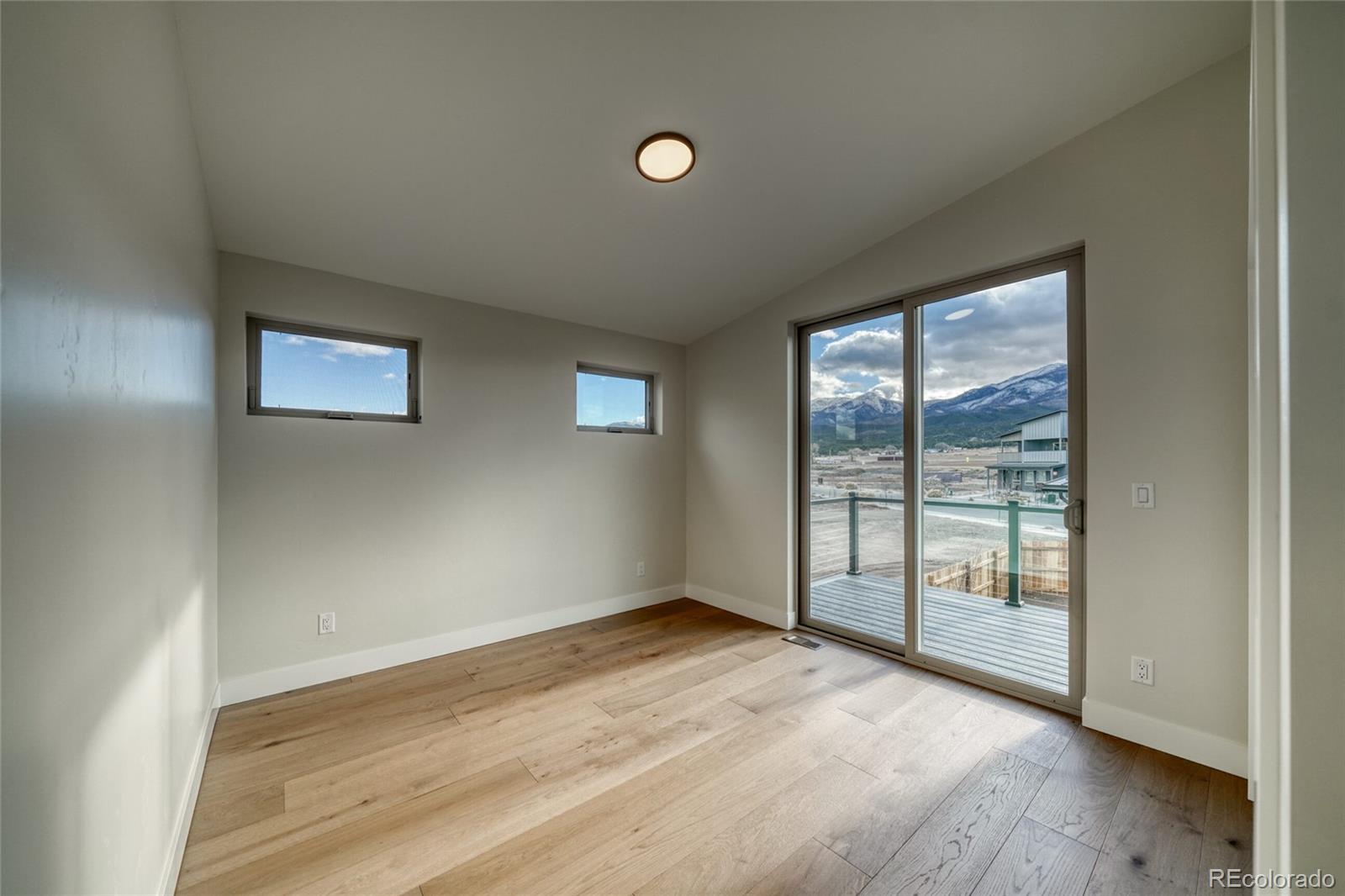 211 Southside Loop Salida, CO 81201 - Photo 32 of 39 an empty room with wooden floor and windows