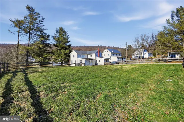 a view of a house with a yard and sitting area