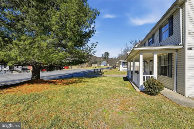 a view of a house with swimming pool and sitting area