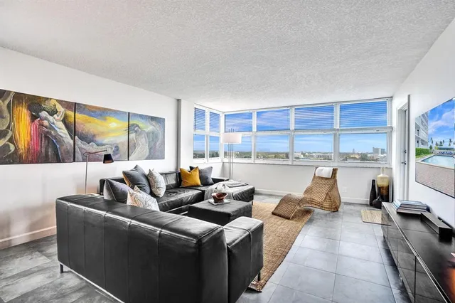 a bedroom with a large bed and a large window