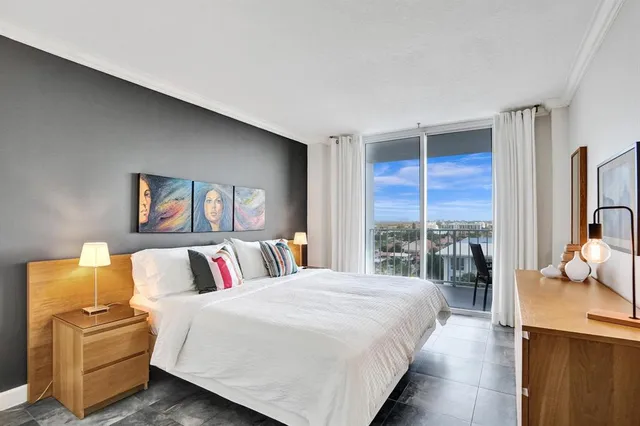 a bedroom with a bed and glass door