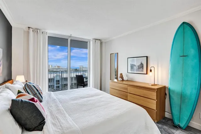 a bedroom with a bed and glass window