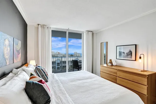 a bedroom with a bed and a large window