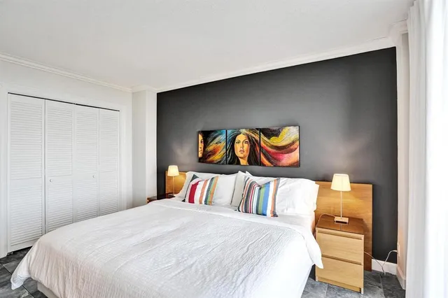 a bedroom with a bed and window