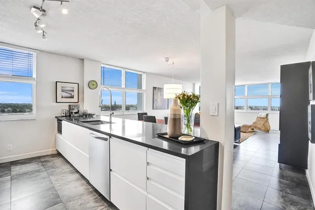 a kitchen with stainless steel appliances granite countertop a sink and a stove