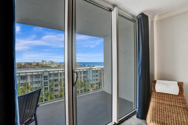 a living room with fireplace furniture and a large window
